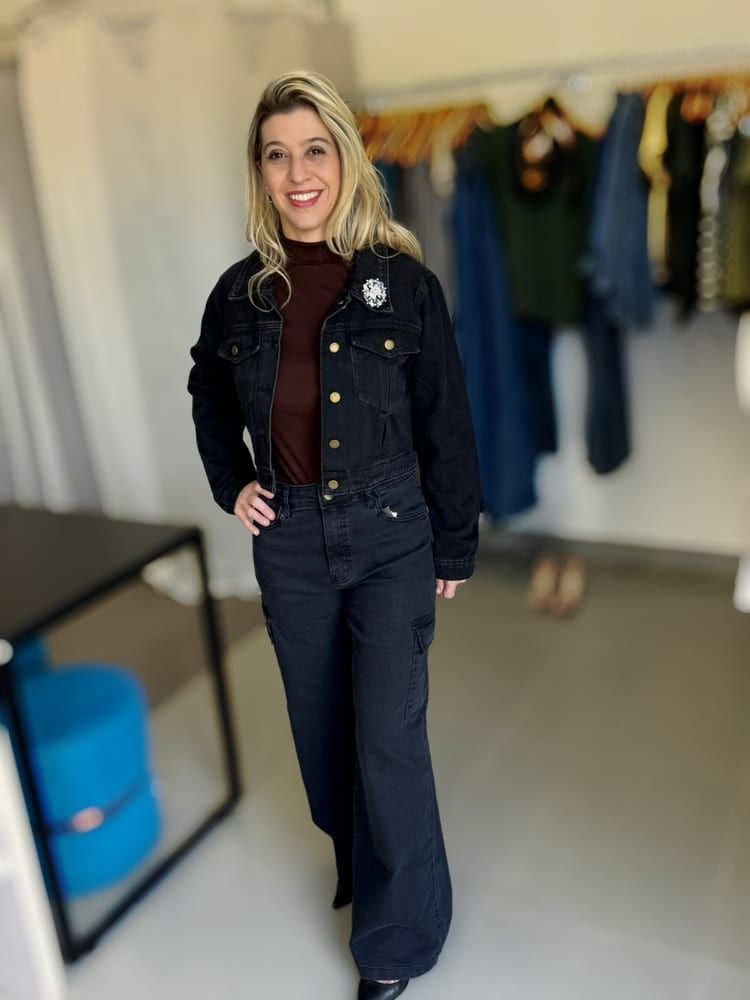 Jaqueta jeans preta e calça cargo pantalona da coleção MASÔ, vestidas por uma cliente na loja